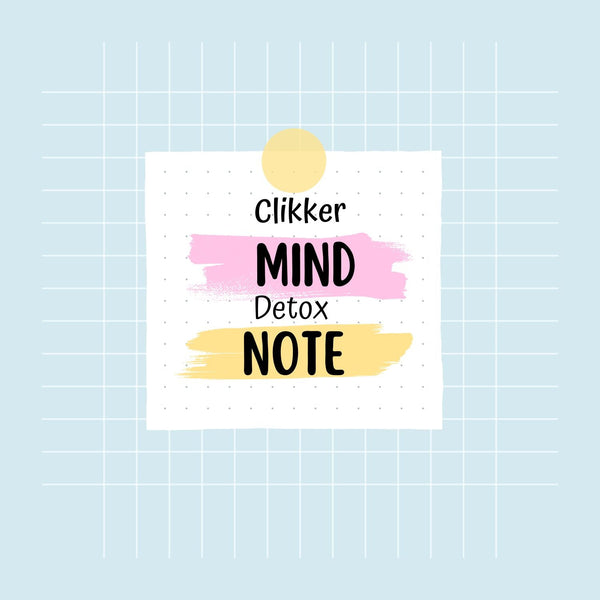 Notebook with 'Clikker Mind Detox Note' on a light blue grid background